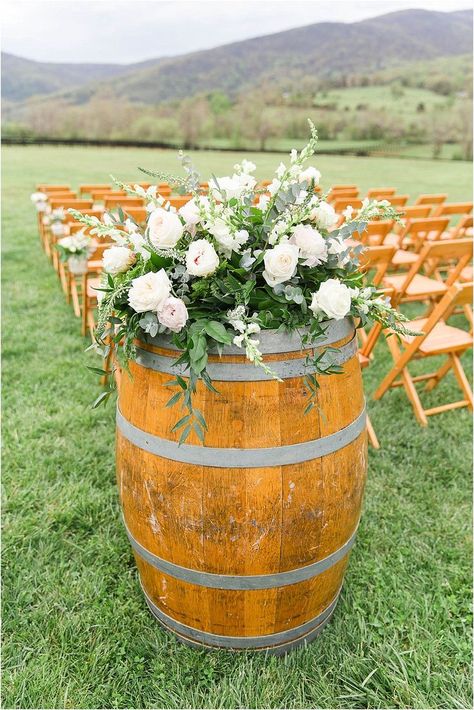 Wine Barrel and ivory white flowers inspo for outdoor wedding ceremony Flowers On Wine Barrel, Wine Barrel Arrangements Wedding, Barrel Arrangements Wedding, Wine Barrel Ideas Wedding, Wine Barrel Floral Arrangement, Barrel Flowers Wedding, Wine Barrel Flower Arrangements, Wine Barrel Flowers, Wedding Barrel