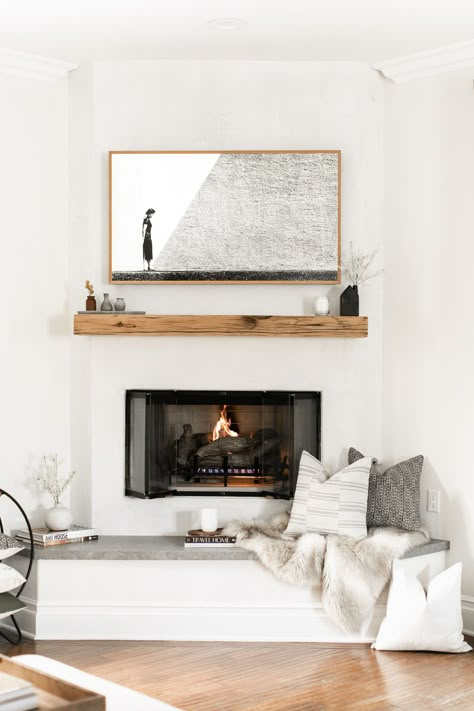 The coziest spot to enjoy a cup of coffee.  Even fireplaces love pillows! Photo by Public311 Design for Elsie Home.  #fireplacestyling #fireplacehearth #plasterfireplace #floatingmantel #livingroomstyling #familyroomstyling #designerpillows #designertextiles #throwpillows #decorativepillows #cozycorner #californiacasual #interiordesign Plaster Fireplace, Fireplace Styling, Reclaimed Wood Mantel, Fireplace Seating, Floating Mantel, Brick Fireplace Makeover, Fireplace Hearth, Corner Fireplace, Fireplace Remodel