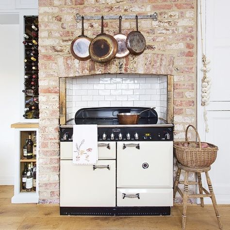 If you don't fancy a whole room full of rustic character, why not limit it to just one area of your kitchen? This range cooker has been fitted into an exposed brick chimney breast for a marvellously country-style centrepiece. Copper pans, a ceiling height wine rack, basketry and plaited garlic all press the style home Range Cooker Kitchen, Apartment Bed, Baños Shabby Chic, Shabby Chic Apartment, Cocina Shabby Chic, Chic Apartment, Apartment Chic, Shabby Chic Dresser, Chimney Breast