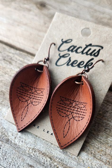 These earrings are made from genuine leather, machine engraved, lightly oiled, then hand burnished to a bright shine. Finished with antique gold findings. Diy En Cuir, Handmade Leather Jewelry, Leather Tooling Patterns, Laser Engraved Leather, Leather Jewelry Diy, Cowgirl Jewelry, Leather Workshop, Sewing Leather, Western Leather