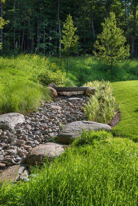 A Vermont mountain getaway nestled into a heavily wooded site Dry Riverbed Landscaping, Dry River Bed, Dry Stream, Boulder Garden, Vermont Mountains, Dry River, River Rock Landscaping, Hillside Landscaping, Pond Landscaping