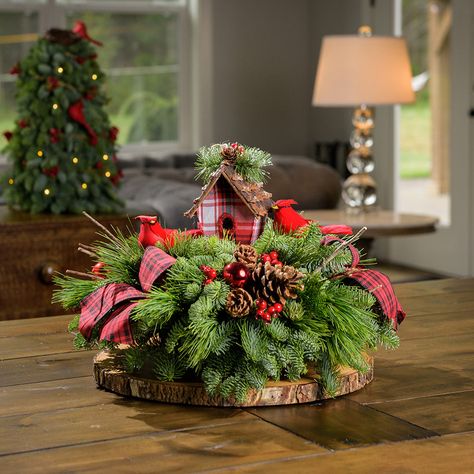 Inspired by the delight of glimpsing the striking red feathers of a cardinal flutter through the forest, our Cardinal Cottage centerpiece is a truly cherished addition to the home of any bird or nature lover! This Christmas centerpiece features two adorable bright red cardinal birds nestled in close to a rustic birdhouse and surrounded by a forest of fresh noble fir, white pine, and incense cedar. Their bountiful home is teeming with cheery red faux berries, pinecones, shiny red balls, and is ac Cardinal Cottage, Cottage Centerpiece, Cardinal Christmas Decor, Christmas Decorations Centerpiece, Christmas Log, Winter Arrangements, Rustic Birdhouse, Christmas Table Centerpieces, Tabletop Christmas Tree