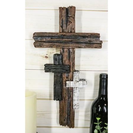 This 3 Tone Trinity Family Wall Cross is made of polyresin, handpainted and polished individually.  This 3 Tone Trinity Family Wall Cross measures approximately 11.75" tall, 7.5" wide and 1" deep. The wall cross weighs about 14 ounces.  This rustic wall cross features a large cross in walnut color accompanied by two smaller crosses in birch and driftwood finish. It is a beautiful representation of your faith and your little ones as the Book Of Joshua inscribed 'As for me and my house, we will se Metal Rooster Decor, Dragonfly Garden Decor, Driftwood Color, Book Of Joshua, Dragonfly Wall Decor, Fence Pickets, Cross Decor, Driftwood Finish, Wooden Crosses