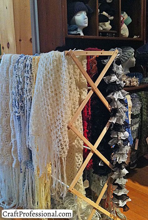 Crocheted blankets displayed on a clothes drying rack Crochet Craft Fair, Scarf Display, Craft Show Booths, Crocheted Blankets, Fair Display, Craft Fairs Booth, Craft Booth Displays, Craft Fair Displays, Craft Display