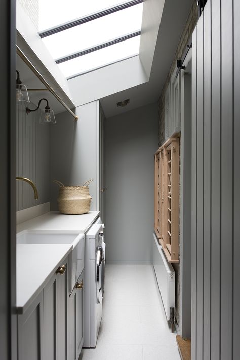 A functional use of a compact space in this utility room in a recently completed project in Dartmouth Park, North London. Ideal components of a utility are a rail for hanging, sink, drying rack, integrated laundry basket and a bench large enough to fold clothes. London Utility Room, Utility Room With Clothes Rail, Utility Room With Island, Utility Room In Kitchen, Utility Room Narrow, Windowless Utility Room, Long Utility Room, Utility Room In Garage, Utility Sunroom