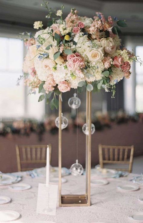 You’ve probably decided what your wedding theme is. Wedding reception centerpieces should be beautiful, but they don’t have to be difficult. There’s no need... Cheap Wedding Table Centerpieces, Wedding Table Pink, Tall Wedding Centerpieces, Gubahan Bunga, Tafel Decor, Wedding Floral Centerpieces, Tall Centerpieces, Flower Centerpieces Wedding, Wedding Table Decorations