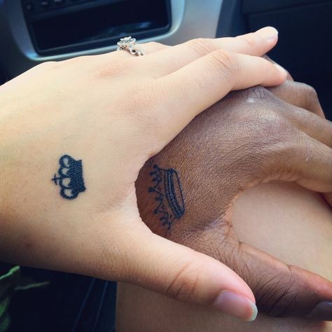 Couples king and queen tattoo. Interracial couple. King And Queen Hand Tattoo For Couples, Crown Tattoo Couple, King N Queen Tattoo Couple, Couple Tattoos King And Queen Crowns, Crown Couple Tattoos King Queen, Queen Tattoo, Interracial Couples, Couple Tattoos, Paw Print Tattoo