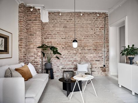 Scandinavian living room with exposed brick wall Brick Wall Living Room, Brick Wall Decor, Brick Feature Wall, Brick Living Room, Brick Interior Wall, Brick Interior, Minimalist Living Room Decor, Scandinavian Apartment, Living Room Scandinavian