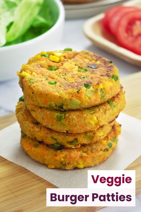 Four vegetarian burger patties made from couscous stacked on a wooden surface with tomato and lettuce shown in the background Burger Patty Recipe Vegetarian, Veg Patty For Burger, Vegetarian Patty Recipes, Veggies Burger Recipe, Subway Veggie Patty Recipe, Vegetable Burger Patties, Vegetable Burgers Recipe, Veg Burger Patty Recipe, Veggies Patties