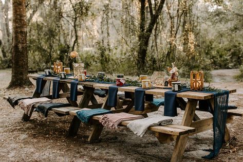 picnic style wedding reception table at Canoe Outpost Summer Camp wedding design. Orange Blossom Bride | Central Florida Wedding Blog  #campingwedding #outdoorwedding #weddingdesign #weddinginspiration #weddingideas #weddinginspo Camper Wedding Theme, Camping Picnic Table Decor, Summer Camp Wedding Reception, Wedding Reception Picnic Tables, Log Cabin Wedding Reception, Picnic Style Wedding Reception, Camping Wedding Reception, Picnic Table Wedding Decor, Camp Style Wedding