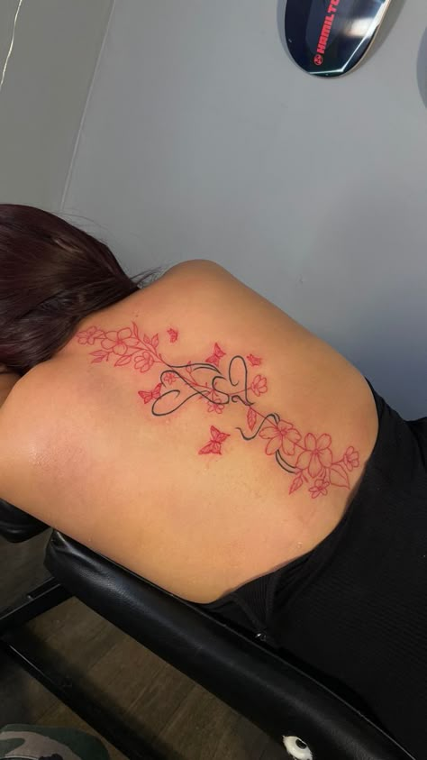 Spine Unique Tattoos, Small Red Back Tattoo, Spine Tattoos For Women Japanese Letters Red, Red Spine Tat, Low Back Flower Tattoo, Back Tattoo Flowers Women, Spine Tattoo And Tramp Stamp, Black And Red Spine Tattoo, Red Flower Back Tattoo