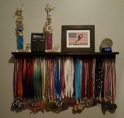 Gymnastics medal/trophy display shelf Medal Award Display, Medals And Certificates Aesthetic, Gymnastics Trophies, School Medals Aesthetic, Trophy Aesthetic, Medals Aesthetic, Gymnastics Trophy, Trophy Display Ideas, Medal Display Ideas