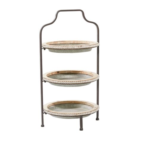 "Grey Metal Farmhouse Tiered Server Organize your home spaces with this farmhouse grey galvanized 3-tier metal serving tray with wood accents. Each galvanized metal tier plate is decked with wooden accent rims and wood beads with natural light brown finish. This ensemble is held together by an iron frame that extends to a single handle and 4 feet to hold it up. Placed on your indoor or outdoor tables, this 3-tier serving tray is a charming blend of modern and rustic vibes for your farmhouse-them Farmhouse Grey, Metal Farmhouse, Tiered Server, Accent Tray, Metal Serving Trays, Tiered Serving Trays, Round Serving Tray, Grey Metal, Metal Tile