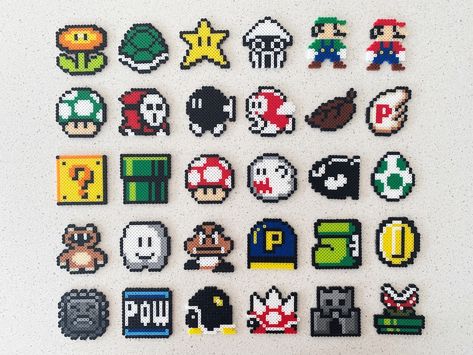 Super Mario Bros Elements Perler Beads Art- Nintendo Video Game- Can be Fridge Magnet, Keychain, Phone Charm, and Badge! “It’s-a me, Mario!” Here we have all of the elements in Super Mario Bros! The block, the mushroom, the coin, the fire flower, etc. Come on find the elements you like for your Super Mario Brothers Perler Beads, Super Mario Bros Perler Beads, Perler Bead Bowser, Perler Beads Ideas Mario, Disco Ball Perler Beads, Hama Bead Keychain, Perler Beads Video Games, Perler Beads Games, Gaming Perler Beads