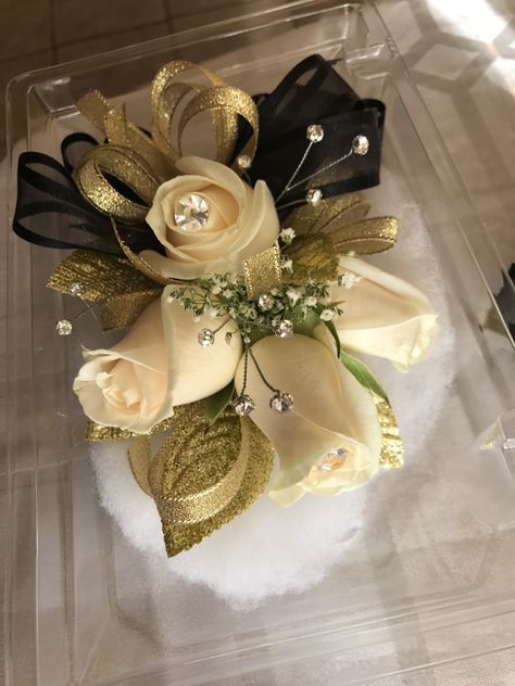 Gold Dress Corsage, Black Gold Corsage, Black And Gold Wrist Corsage, Corsage To Go With Black Dress, Black And Gold Prom Flowers, Black And Gold Prom Bouquet, Black And Gold Prom Aesthetic, White And Gold Corsage And Boutonniere, Corsage For Gold Dress