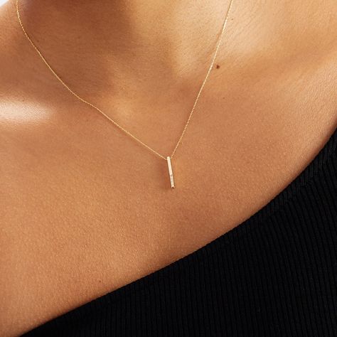 "Our Solid Gold Diamond Vertical Bar Necklace is perfect for all the classic-lovers out there. With being gorgeous and elegant, it is an essential for your jewelry box.  F E A T U R E S * Made to Order. * Gold KT: 14K * Choice of Gold Color: Yellow Gold, Rose Gold, White Gold * Diamond Quality: Diamond carat: 0.02 ct. Clarity: VS2 Color: F-G Cut: Excellent cut Diamond type: Natural Setting Type: Prong Setting * Pendant Height: 15 mm / 0.59 inch * Pendant Width: 1 mm / 0.03 inch * Length: 14\", 1 Grad Necklace, Minimalist Accessories Jewellery, Simple Necklace Designs, Gold Pendant Set, Bar Necklaces, Vertical Bar Necklace, White Gold Necklace, Vertical Bar, Diamond Bar