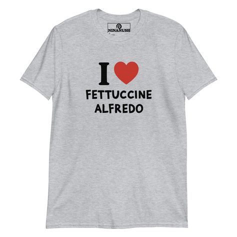 The I love fettuccine Alfredo t-shirt! A classic t-shirt for pasta lovers that stands out and makes a bold statement. Wear this funny foodie shirt and show off your fettuccine passion. It's a soft and comfortable tee, designed for fettuccine Alfredo enthusiasts and made just for you. This quirky shirt is the perfect unique graphic tee to add some personality to your outfits or a funny gift for a fellow fettuccine Alfredo lover.    * 100% ring-spun cotton  * Dark Heather is 65% polyester, 35% cot Foodie Outfit, Quirky T Shirts, Pickled Garlic, Fettuccine Alfredo, Weird Holidays, Happy Design, Funny Graphic Tees, Kids Swimwear, Funny Graphics