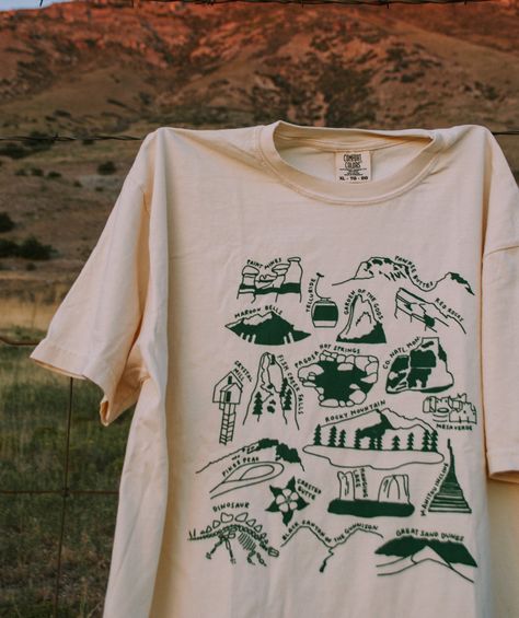 Our tribute to the nature in Colorado! This designs features all 4 national parks and 15+ other beautiful spots from Grand Junction to Denver. Let it remind you of the places you've been and inspire you to see the rest!  This item will ship within 1-2 business days of ordering. If combined with a made-to-order item, we National Parks Tshirt, Nature T-shirt, National Parks Shirt, Outdoor Graphic Tees, Nature T Shirt, Adventure Tshirt Design, Travel T Shirt, Granola Shirts, Nature Shirt Design