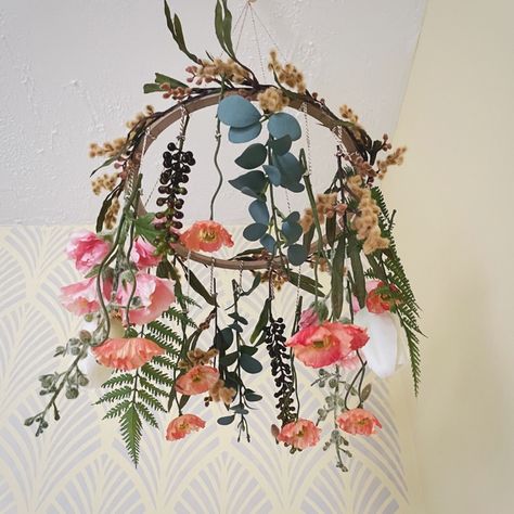 The mobile includes a combination of silk and artificial flowers mirroring the spring blooms you might find growing outside. Poppies, mimosa, tulips, hollyhock and eucalyptus dance together as they dangle down from the spherical structure holding them together. The mobile helps you and your baby to connect with nature through each unique bloom.

#babynursery #nurseryinspo #nurserydecor #expecting #babyprep #motherhood #parenthood #upcycle #babymusthaves Wild Flower Baby Mobile, Dried Flower Nursery, Baby Girl Nursery Nature Theme, Flower Garden Nursery Theme, Wildflower Mobile Nursery, Wildflower Theme Nursery, Poppy Nursery Theme, Nursery Wildflower Theme, Baby Girl Nursery Wildflower Theme