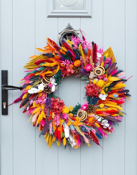 A large handmade dried flower wreath in a mixture of bright, rainbow colours. Perfect for a uniquely colourful Christmas! Measures approximately 55 - 60cm in diameter. The wreath comes supplied with a length of natural twine attached with which to hang. We recommend that dried flower wreaths are displayed indoors only to ensure their longevity. Unique Door Wreaths, Colourful Christmas Wreath, Amazing Christmas Decorations, Unique Christmas Wreaths, Colourful Wreath, Colorful Christmas Wreath, Dried Flower Christmas, Flower Christmas Wreath, Colorful Wreaths