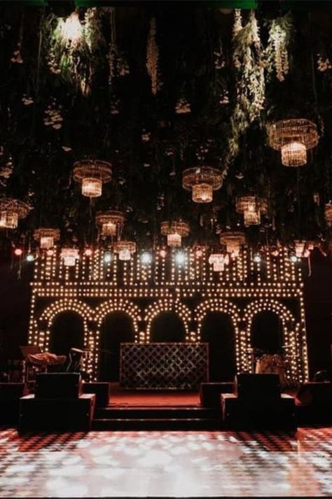 Beautiful & Unqiue Stage Decor Ideas for your wedding funtions. #weddingbazaar #indianwedding #stagedecorringceremony #stagedecorwedding #stagedecorreception #stagedecorengagement #stagedecorsimple #stagedecorideas #stagedecorgrandwedding #stagedecorsimplewedding #stagedecorhaldi #stagedecorsangeet #stagedecor Cocktail Party Stage Decor, Reception Decor Ideas Indian, Sufi Stage Decor, Sangeet Stage Design, Cocktail Party Decorations Night Indoor, Sangeet Dance Stage, Sangeet Theme Ideas Indoor, Sangeet Led Stage, Black And Gold Reception Decor