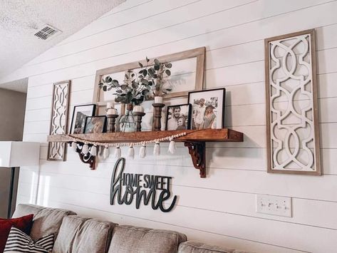 Floating Shelves Living Room Long Wall, Decorating Around Windows Living Rooms, Western Boho Shelf Decor, Modern Farmhouse Artwork Wall Decor Living Room, Shelf Decor Above Couch, Shutter Wall Decor Ideas Living Rooms, Above The Couch Art, Farmhouse Floating Shelves Living Room, Behind Couch Wall Decor Farmhouse