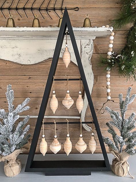 If you are looking for an inexpensive way to have a Christmas tree that is unique and doesn't take up a lot of space, click over to see how to make this DIY Christmas tree with scrap wood! Wood Xmas Tree Ideas, Diy Triangle Christmas Tree, Wood Xmas Trees Triangle, A Frame Christmas Tree, Wooden Frame Christmas Tree, Triangle Wood Christmas Trees, Wooden Diy Christmas Tree, Scrap Wood Christmas Tree Diy, Diy Wood Trees Christmas