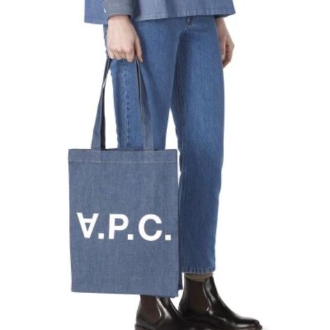 Nwt A.P.C. Japanese Light Indigo Denim Tote Bag. One Size. Pristine. Never Been Used. Durable And Sleek! Japanese Fabric. Large Topstitched Hem At Top Of Bag. Two Handles With X Topstitching. May Be Carried On Shoulder Or By Hand. Long Band, Cut In A Single Piece, On Sides And At Bottom. Contrasting 'V.P.C.' Motif Silkscreened On Front. Interior Pocket Suspended At Top From Hem. Tone-On-Tone Cotton Tape On Interior Seams. Dimensions: 12 X 14.56 X 3.14 In. 100% Cotton. Denim Tote Bags, Indigo Denim, Denim Tote, Japanese Fabric, Single Piece, Womens Tote Bags, A P, Handles, Sleek