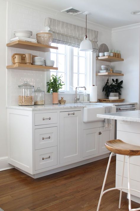 We love Caitlin's bright white kitchen with warm wood shelves with perfect items they use everyday. #openshelving #whitekitchen #farmsink Small White Kitchen Decor, White With Wood Kitchen, Small Bright Kitchen, Cute White Kitchen, Wood House Design Interior, Cozy White Kitchen, All White Kitchen Ideas, Small Kitchen White, Small White Kitchen Ideas