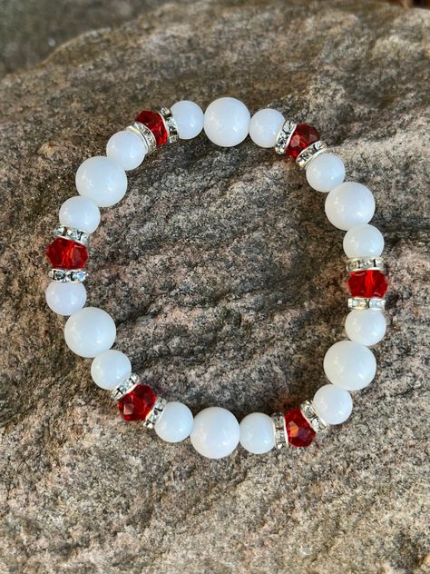 This bracelet is made with white glass beads, rhinestone spacers and red faceted beads. Note: Colors may vary depending on your monitor Shipping Info: All orders are shipped from Canada and they are sent through Canada Post.  If you would like expedited shipping it will cost more and reach out and I can give pricing. Within Canada: Sent regular mail with no tracking.  It can take 5-10 business days to arrive. United States: Sent with tracking  International: Sent International Air and on average Girly Bracelets, Braided Bracelet Diy, Red Beaded Bracelet, Bracelet Sets, Bracelets Design, Diy Bracelets Patterns, Beads Bracelet Design, Jewelry Accessories Ideas, Christmas Bracelet