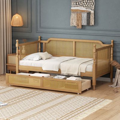 Elevate your bedroom with the timeless elegance and natural charm of our exquisite rattan bed. Handcrafted from durable natural rattan and solid pine wood, this bed blends rustic, retro aesthetics with modern comfort. Its French Provincial design, inspired by old-world European furnishings, transforms any room into a stylish and restful retreat. Available in two sizes and colors, this bed is more than just a place to sleep—it's the centerpiece of your bedroom. Complete Your Bedroom: Explore our full collection, including matching beds, nightstands, a 4-drawer vanity table, and a daybed with a trundle—designed in the same beautiful style. Bay Isle Home™ Size: Twin, Color: Walnut | Bay Isle Home™ Daybed w / Drawers brown / greenWood in Walnut | Twin | Wayfair Rattan Bed Frame, Full Size Daybed, Wooden Daybed, Rattan Daybed, Daybed With Drawers, Rattan Style, Rattan Design, Rattan Bed, Rattan Headboard