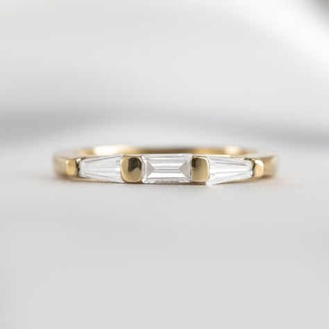 Our incredible Dillion Baguette Diamond Wedding Ring is a stunning, vintage-inspired piece that exudes twenties elegance. Featuring a central baguette diamond flanked by two tapered baguette diamonds, the Dillon wows with its presence and sparkle. Perfectly complementing the Devon Diamond Baguette Engagement Ring, the Dillon is also a striking standalone piece. The polished, geometric silhouette of this baguette ring creates true impact, partnering with any ring to create a decadent vintage stac Wedding Rings Baguette, Tapered Baguette Wedding Band, Baguette Ring Band, Baguette Wedding Rings, Baguette Diamond Wedding Band, Baguette Wedding Band, Baguette Engagement Ring, Marquise Diamond Engagement Ring, Diamond Baguette