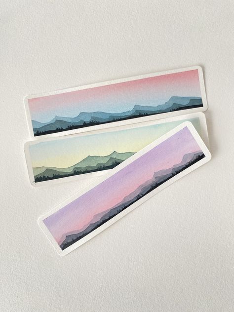 "These stunning watercolor bookmarks are perfect for marking the place in your favorite book! The watercolor designs are inspired by beautiful skies and serene mountains. Choose your favorite one or order 3 to complete the set! These make perfect gifts. - each bookmark is handmade - dimensions are 1.5\" by 5.5\"  Please contact me if i can improve your order and make it perfect for you!" Watercolor Mountain Bookmark, Watercolor Bookmarks For Men, Water Colour Bookmarks, Watercolor Bookmarks Ideas, Watercolour Bookmarks, Bookmark For Kids, Bookmark Watercolor, Painted Bookmarks, Books Bookmark