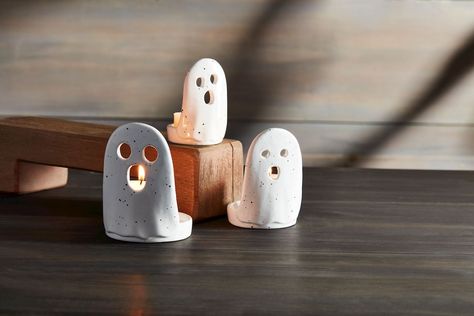 Nested set of three hand-painted speckle ceramic ghost holds tea lights. Dimensions: small 3 1/2" x 2" dia | medium 4" x 2 1/2" dia | large 4 1/2" x 2 3/4" dia Material: Dolomite Medium Ghost, Ceramic Ghosts, Ceramic Ghost, Happy Halloweenie, Halloween Clay, Diy Air Dry Clay, Interior Design Books, Pottery Classes, Cozy Atmosphere