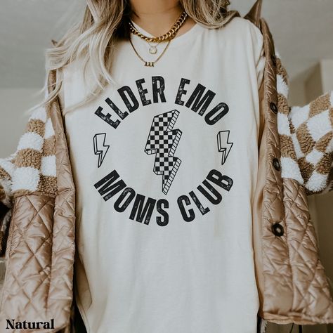 This comfy shirt is the perfect gift for the elder emo in your life. You know, the one that has never stopped loving those old pop punk hits and still goes to every reunion concert/festival they can find. Maybe you're the elder emo that can't get enough of that nostalgia. Gift yourself with this comfy shirt and go jam out. Each shirt is custom made at the time you order it. Please note: Colors may appear slightly different in-person due to computer/phone screens.  SIZE: ❤ This is a regular unise Elder Emo, Scene Shirt, Emo Phase, Punk Shirt, Mama Style, Comfy Shirts, Pop Punk, Edgy Outfits, Mom Style