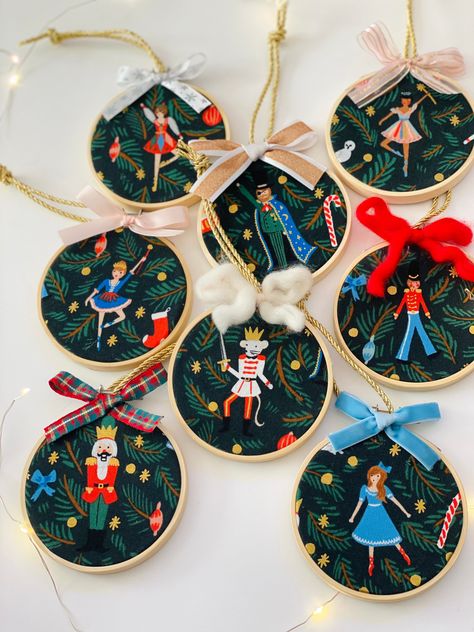 "Ribbon embellishments may vary from what is in the photos but each dancer will be topped with an adorable complementary bow. Purchase one ornament or the entire set of 8 characters.  This sweet nutcracker ornament set is made from the 2021 Rifle Paper Co Holiday Classics line of fabric. Each character is centered within a 3\" embroidery hoop and embellished with an adorable bow.  These little ornaments could also be used as gift wrap decorations or place settings at the dinner table. These have Christmas Embroidery Ideas, Ribbon Embellishments, Ballerina Ornaments, Watercolor Art Diy, Nutcracker Ornaments, Nutcracker Ballet, Glitter Glass, Nutcracker Christmas, Christmas Embroidery