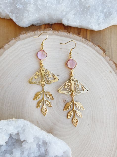 A unique pair of boho, dusty pink butterfly earrings inspired by magic, earth and sky. These lightweight dangle hook earrings are handmade and feature raw brass details and morganite and citrine quartz connectors. The detailed butterflies, and hanging vines will add a goddess vibe to any outfit.  Each pair comes complete with a drawstring bag and gift box making them the perfect gift.  Morganite and Citrine Quartz Butterfly Earrings Nickel Free Ear Hooks Height: 4.25 in Brass: Butterflies, Leave Celestial Boho, Earthy Earrings, Hanging Vines, Fancy Earrings, Butterfly Jewelry, Nature Inspired Jewelry, Pink Butterfly, Butterfly Earrings, Pink Stone