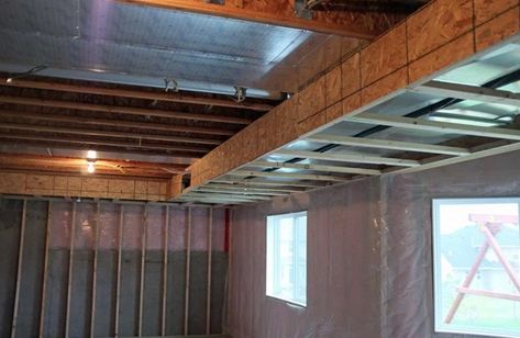 A simple wooden framework, called a soffit, can then be covered with drywall or paneling to hide ductwork and other obstacles. Basement Ceiling Insulation, Basement Ceiling Ideas Cheap, Basement Ceiling Painted, Cheap Basement Remodel, Ceiling Tiles Basement, Basement Remodeling Diy, Basement Ceiling Options, Basement Ceiling Ideas, Basement Bar Plans