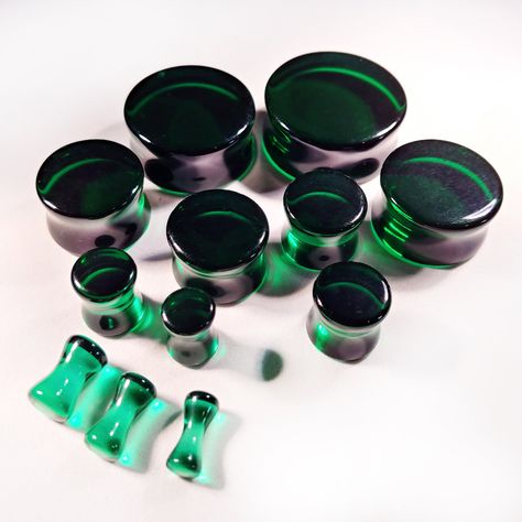 "Dark Green/Black Glass Plugs / Gauges for stretched ears. Double flare. Single flare also available! Sold by the pair. Dark green/black glass plugs are mostly dark green. The smaller pieces will show more light green while the larger plugs will be darker green/black with green showing in bright light. This is from the density of the glass and coloring. These plugs are photographed in bright light. Please keep this in mind when ordering. We have done our best to photograph the widest range of co Plug Earrings Gauges, Tapers And Plugs, Ear Gauges Plugs, Johnson City Tn, Bridesmaid Earrings Gold, Emerald Green Earrings, Ear Piercings Cartilage, Plug Earrings, Piercing Shop