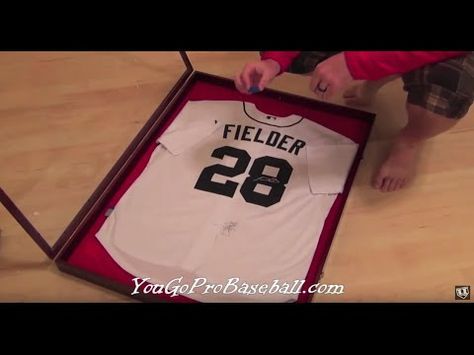 How to frame a baseball jersey for a lot less money - YouTube Frame Jersey Ideas, Shadow Box Jersey, Hockey Projects, Sports Jersey Display, Baseball Shadow Boxes, Jersey Frame, Baseball Scoreboard, Jersey Display Case, Baseball Bedroom