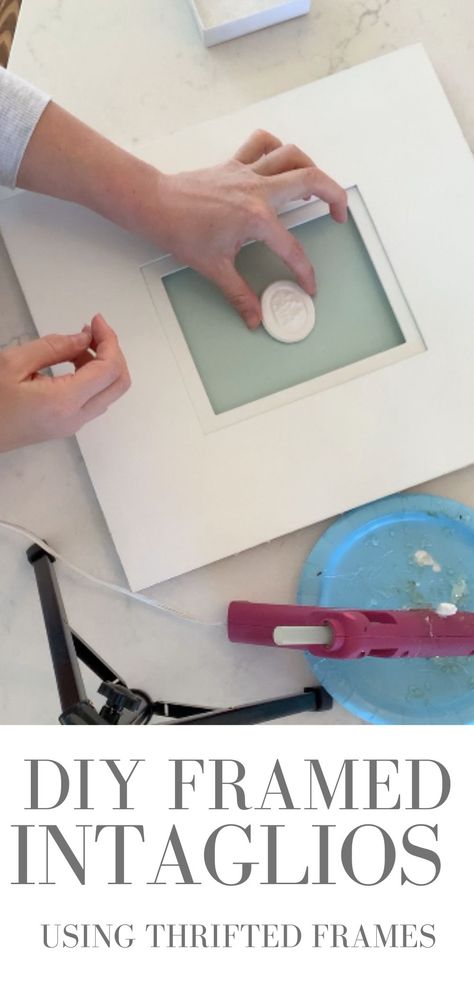 A photo of a hand holding an intaglio in the center of a photo mat with a hot glue gun next to it. How To Gild A Frame, Intaglios Framed Art, How To Frame Intaglios, Diy Vintage Framed Art, Diy Framed Intaglios, Diy Painting Frames Ideas, How To Sign Artwork, How To Make Intaglios, Picture Matting Ideas Diy