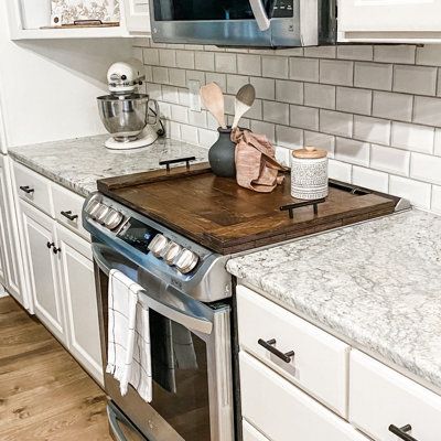 Imagine adding 30 inches of extra counter space to your kitchen. Handmade noodle boards are the perfect way to make better use of your stovetop. Although not food grade, these wooden stove covers are definitely decor-grade. Use a kitchen stove cover to upgrade the look of your stovetop by hiding the unsightly burners and decorating with your favorite spices and kitchen decor. This farmhouse inspired wooden burner cover has been stained in a warm brown to highlight both the natural wood grain and Gas Stove Top Covers, Wood Burner Stove, Stove Covers, Wooden Stove Top Covers, Wooden Stove, Noodle Boards, Stove Burner Covers, Cook Top Stove, Kitchen Handmade