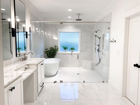 This wet room with white and gray marble tiled walls features a white freestanding tub next to shower behind a glass enclosure. A nickel built-in corner shower bench sits on white grid floor tiles. Tub Next To Shower Ideas, White Subway Tile Shower, Mosaic Shower Tile, Half Wall Shower, Tile Shower Niche, Marble Shower Tile, White Tile Shower, Bathroom With Tub, White Tub