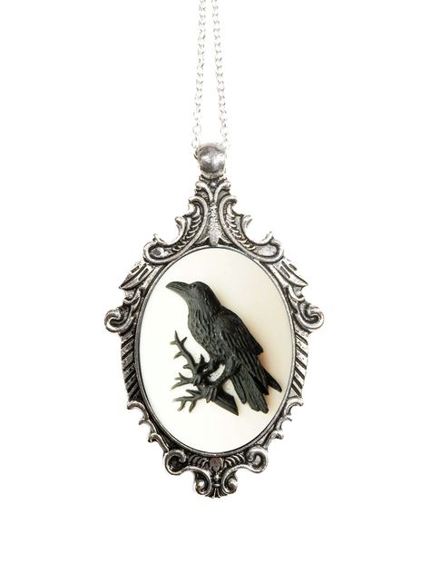 "Styled in a majestic fashion with a feminine twist, the Victorian Raven Cameo Necklace is sure to make a statement! Featuring a beautifully detailed cameo with an ebony black raven bird on a white resin background. The Victorian Raven Cameo Necklace is set in a Victorian-style antique silver-plated pendant. The chain is Sterling Silver-plated and closes with a lobster clasp. The necklace measures approximately 2.5\" long and 2\" wide. The Victorian Raven Cameo Necklace comes with a keepsake org Resin Background, Crow Pendant, Raven Bird, Black Raven, Cameo Jewelry, Antique Pendant, Cameo Necklace, Victorian Jewelry, Keep Jewelry