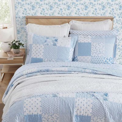 Introducing the Laura Ashley Colleen's Coastal Patchwork Cotton Quilt Set - a captivating combination of coastal allure and timeless design. Elevate your bedroom with the enchanting beauty of this quilt set, meticulously crafted to bring a touch of seaside elegance to your room décor. Colleen's coastal patchwork boasts a harmonious blend of blue tones inspired by the tranquility of the ocean. From darker blues to lighter tones, each patch is intricately arranged to create a visual masterpiece th Double Bed Comforters, Light Blue Bedroom Wall Decor, Coastal Granddaughter Bed Sheets, Coastal Patchwork Quilt, Bed Set Queen, Costal Grandma Bedding, Comfy Blue Bedroom, Light Blue And White Bedroom Decor, Coastal Bedroom Pillows