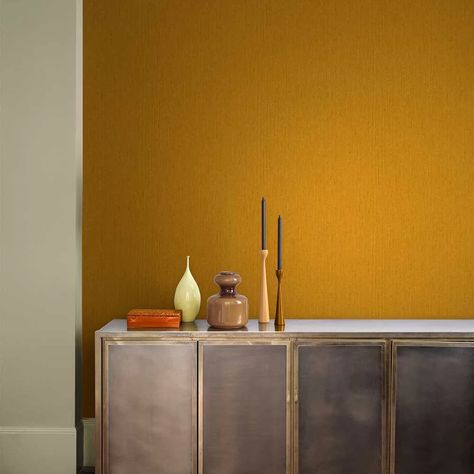 A timeless paper with a subtle sheen and a soft textured finish to elevate any wall. Shown here in the yellow ochre colourway  other colourways available. Note this has a free pattern match. Yellow Plain Wallpaper, Ochre Interiors, Ochre Wallpaper, Living Room Plan, Interior Color Schemes, How To Hang Wallpaper, Plain Wallpaper, Yellow Ochre, Carbon Neutral