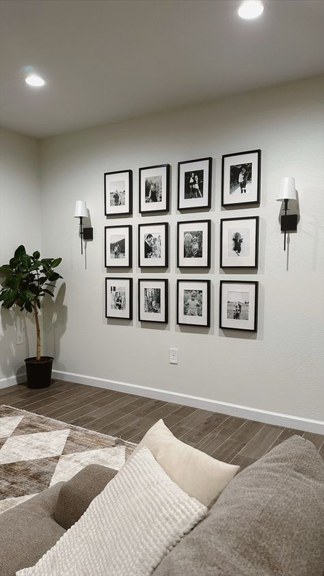 Picture wall, family picture wall, gallery wall, living room decor, neutral home decor, sconces Lounge Room Photo Wall, Home Picture Wall Ideas, Small Living Room Picture Wall, Gallery Wall And Sconces, Lounge Photo Wall Ideas, Photo Wall Collage With Sconces, Photo Gallery Wall With Sconces, Wedding Photo Wall Home Living Room, Couple Photos On Wall Ideas