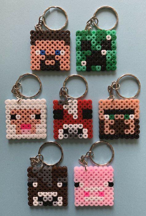 Minecraft Themed Handmade Hama Bead Keyrings  THESE ARE ALL NON OFFICIAL CHARACTER KEYRINGS. NO COPYRIGHT IS INTENDED A Fun Novelty Idea Based On A Minecraft Theme x1 Keyring -  Please Message Us With Which Design You Would Like x2 Keyrings - Please Message Us With Which Designs You Would Like x7 Keyrings -  Made Up Of  x1 Of Each - Steve, Pig, Mushroom Cow, Creeper, Sheep, Brown Cow & Villager x14 Keyrings - Made Up Of x2 Of Each -  Steve, Pig, Mushroom Cow, Creeper, Sheep, Brown Cow & Villager           If You Would Like A Different Mix Please Message Us                                                                                                                                            Not Suitable For Children under The Age Of 3 Years Old Imperfections May Arise as These Are Made T Hama Beads Keyring, Hama Bead Keyrings, Minecraft Melty Beads, Minecraft Pearl Beads, Pixel Beads Ideas, Small Hama Bead Designs, Simple Perler Bead Patterns, Minecraft Handmade, Perler Minecraft