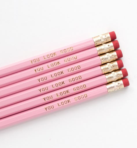 Sweet & feminine, our pink and gold foil You Look Good imprinted pencils are the daily affirmation you need on your desk. Each set contains 6 No. 2 hexagon pencils with gold ferrules and red erasers. DETAILS- wood #2 hexagon pencil- pink barrels, gold ferrule, and red eraser- gold foil imprint- unsharpened- set of 6 pencils- Packaged in cellophane *- Printed in the USA© Graphic Anthology. All rights reserved.Like these pencils? Share them and follow us on Instagram or Pinterest! * Can be shi Preppy Pencils, Tutoring Aesthetic, Lesbian Bar, Preppy School Supplies, Feel Better Gifts, Preppy School, Pink Pencil, School Bag Essentials, Best Pencil