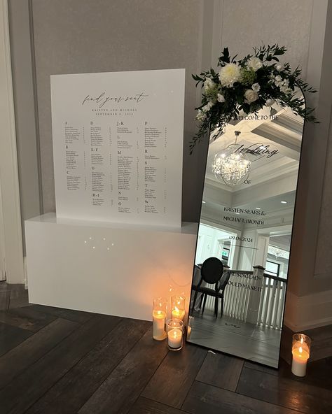 The Most Romantic Trio! We’re in love with how the bride paired a mirror welcome sign with a beautifully designed seating chart and a sleek acrylic base! The reflection of the mirror adds a touch of elegance, while the seating chart guides guests with a sophisticated flair. Just breathtaking… this combo is as sweet as a kiss! 💋👌🖤 #monthillgolfandcountryclub #hamontweddings #weddinginspiration #weddingsignage #weddingsigns #weddingseatingchart #seatingchart #seatingchartideas #seatingplanide... Floor Length Mirror Seating Chart, Wedding Welcome Sign And Seating Chart, Full Length Mirror Wedding, Mirror Welcome Sign, Acrylic Seating Chart, Mirror Seating Chart, Seating Arrangement Wedding, Black And White Wedding Theme, Wedding Mirror